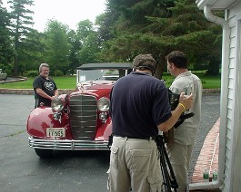 Dick Shappy with his just- completed 1933 V-16 convertible coupe being interviewed by David Robichaud from the channel UPN 38 TV program, "Robi on the Road". The segment was aired July 5, 2005 with a live portion from the Shappy garage showing the many restoration projects now in progress.